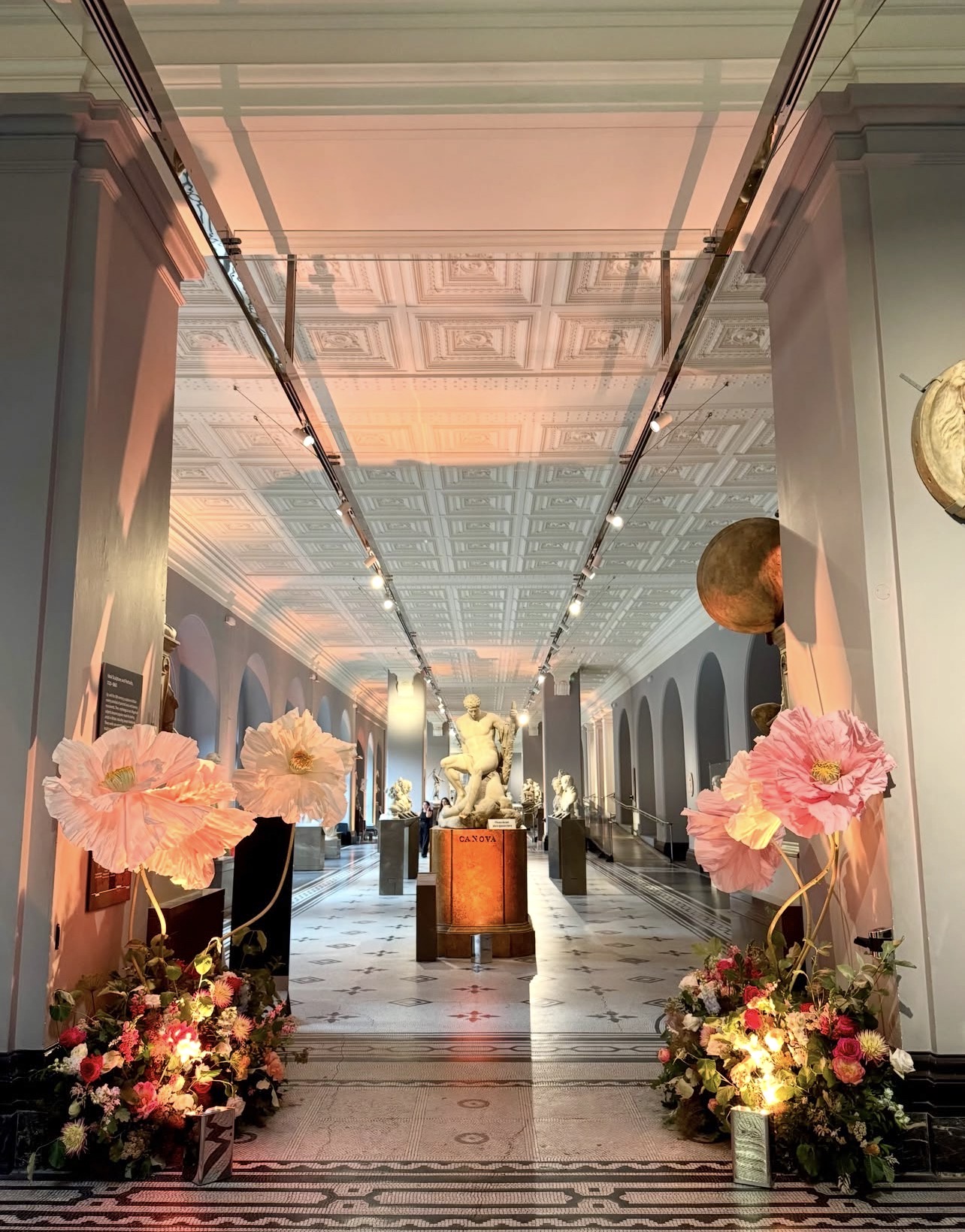 Gallery hall dressed with oversized paper florals for an evening event