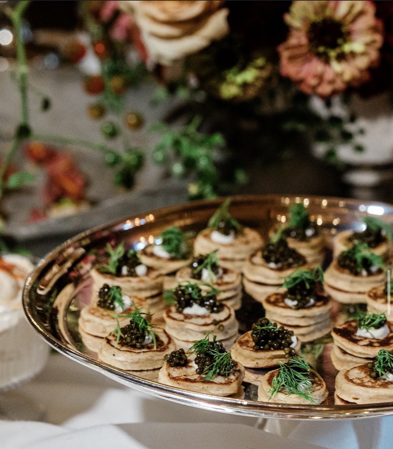 Blini with caviar and dill on a silver platter